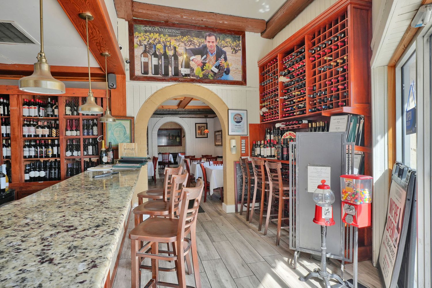 Arched dining salon with wine racks
