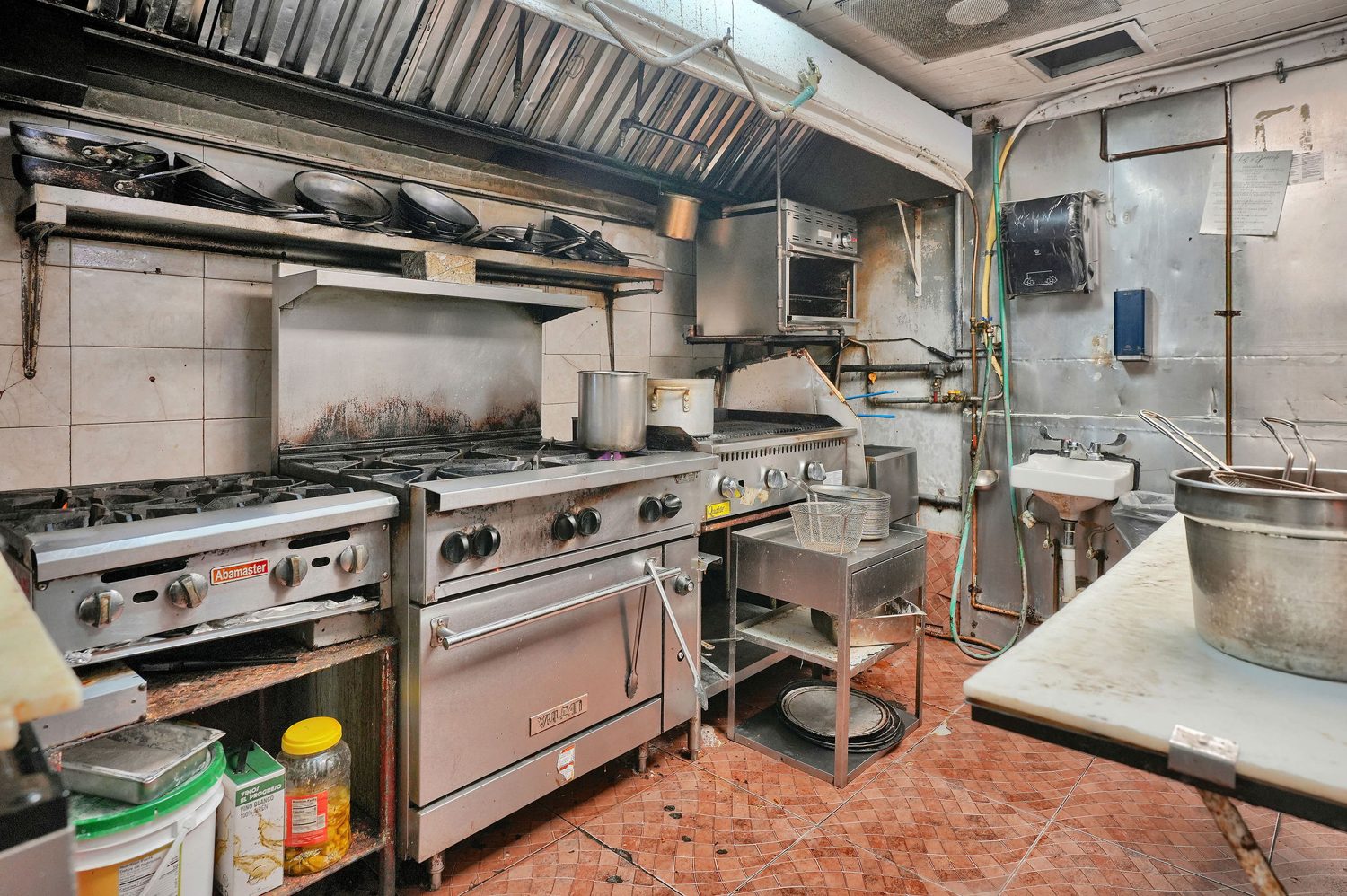 Full commercial kitchen line under hood